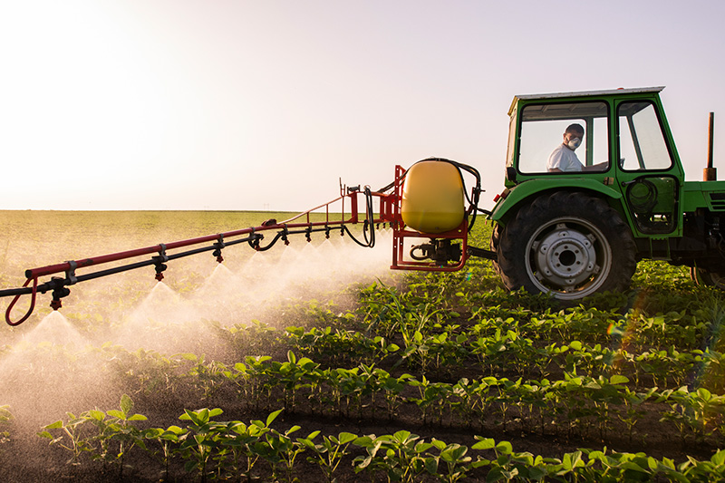 A tractor spraying crops