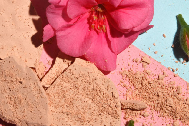 Make-up scattered amongst flowers