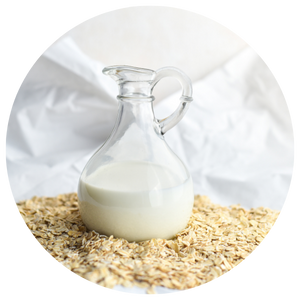 Jug of oat milk on a pile of oats